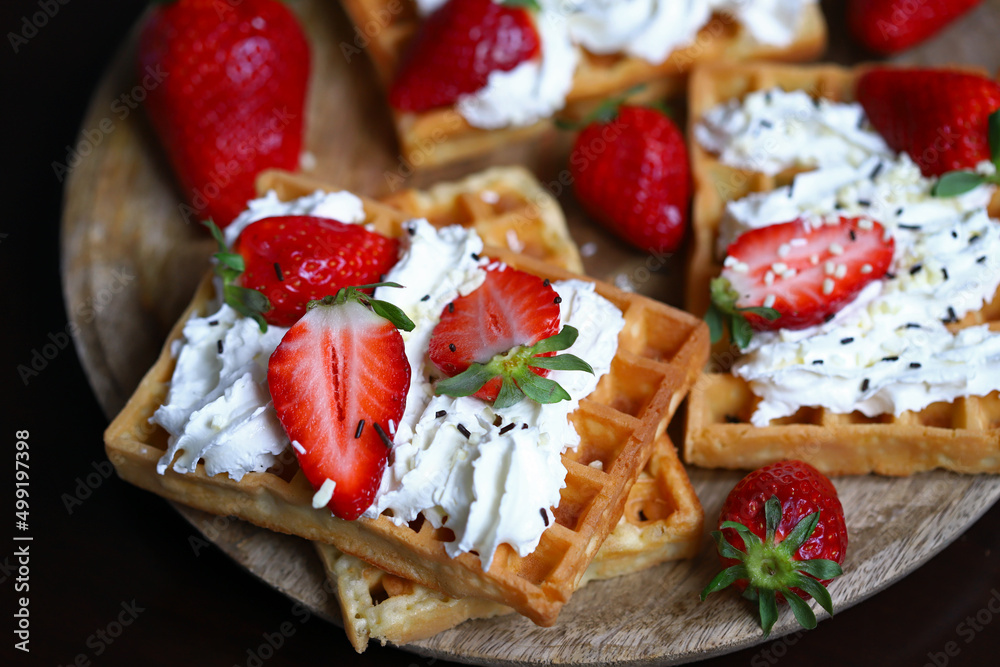 Belgian waffles with strawberries and cream.