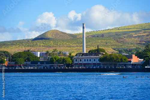 Lahaina old city center seen from the Pacific Ocean in front of the green slopes of the West Maui Nature Reserve - Brick buildings with a chimney west of Maui island in Hawaii photo