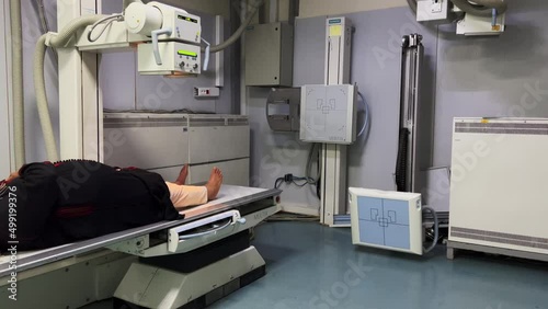 Unrecognizable woman having X-ray scanning session in a public hospital photo