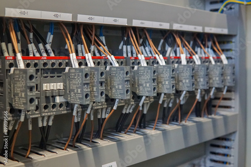 Close-up of electricity control device. Selective focus on minature circuit breaker. Tripped state and blurry on magnetic contactor.