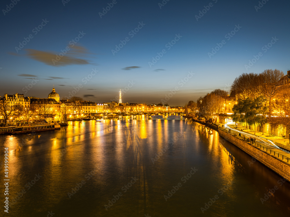 Pont des Arts bridge over River Seine and eiffel tower at night