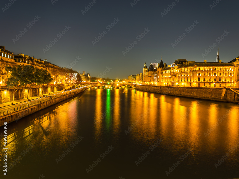 Seine river and the Louvre Castle illumiated at night