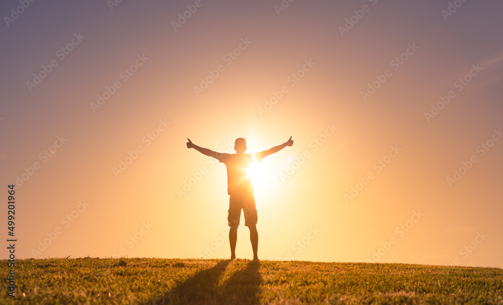 young happy man in nature feeling positive, and optimistic 