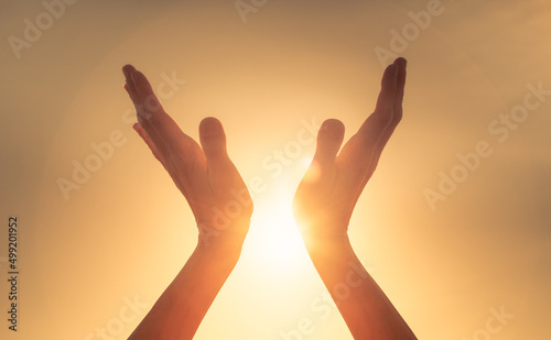 hands in the sky touching the sunlight. feelings of hope and inspiration  