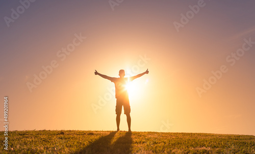 young happy man in nature feeling positive, and optimistic  photo