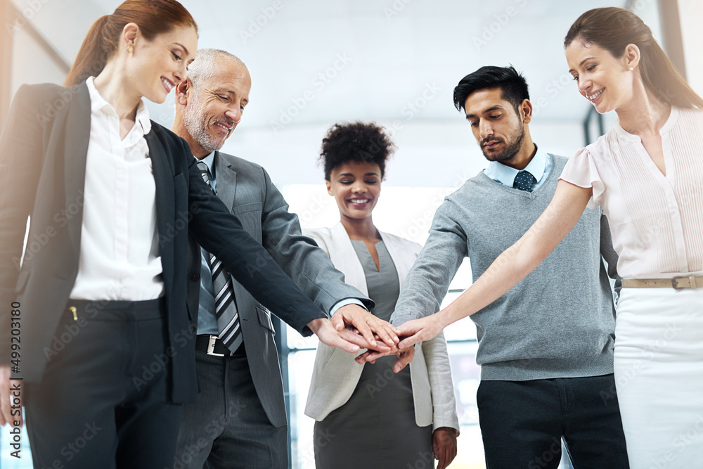 Success is even better when its shared. Shot of a diverse team of colleagues joining their hands together in solidarity. Success is even better when its shared. Shot of a diverse team of colleagues joining their hands together in solidarity.
