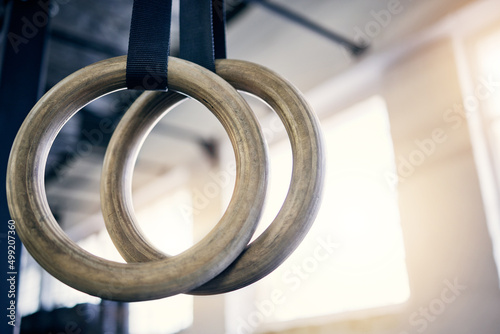 The best equipment to work on both strength and flexibility. Closeup shot of gymnastic rings in a gym. photo