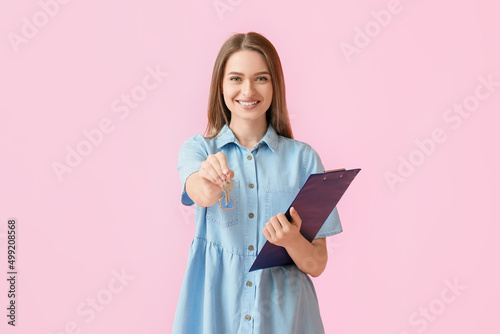 Smiling young woman with ke...