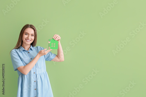 Smiling young woman with ke...