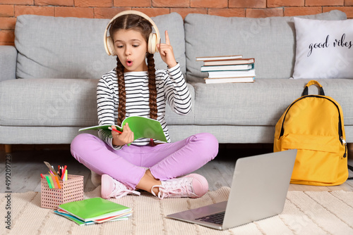 Little girl in headphones h...