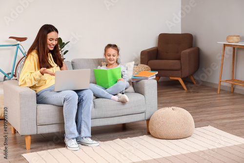 Cute girl studying with tut...
