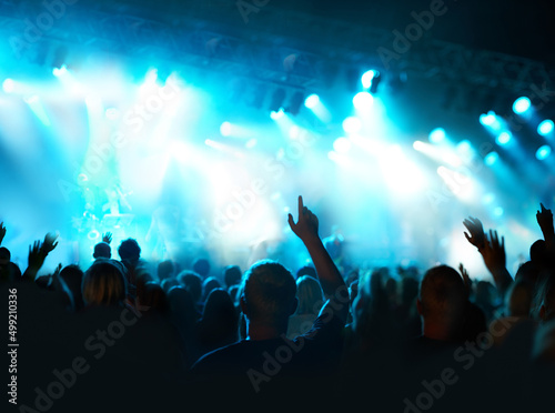 Music in the night under the lights. Shot of a fans watching a live concert. © Arcurs Co-op/peopleimages.com