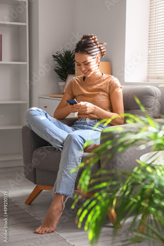 Young barefoot woman using ...