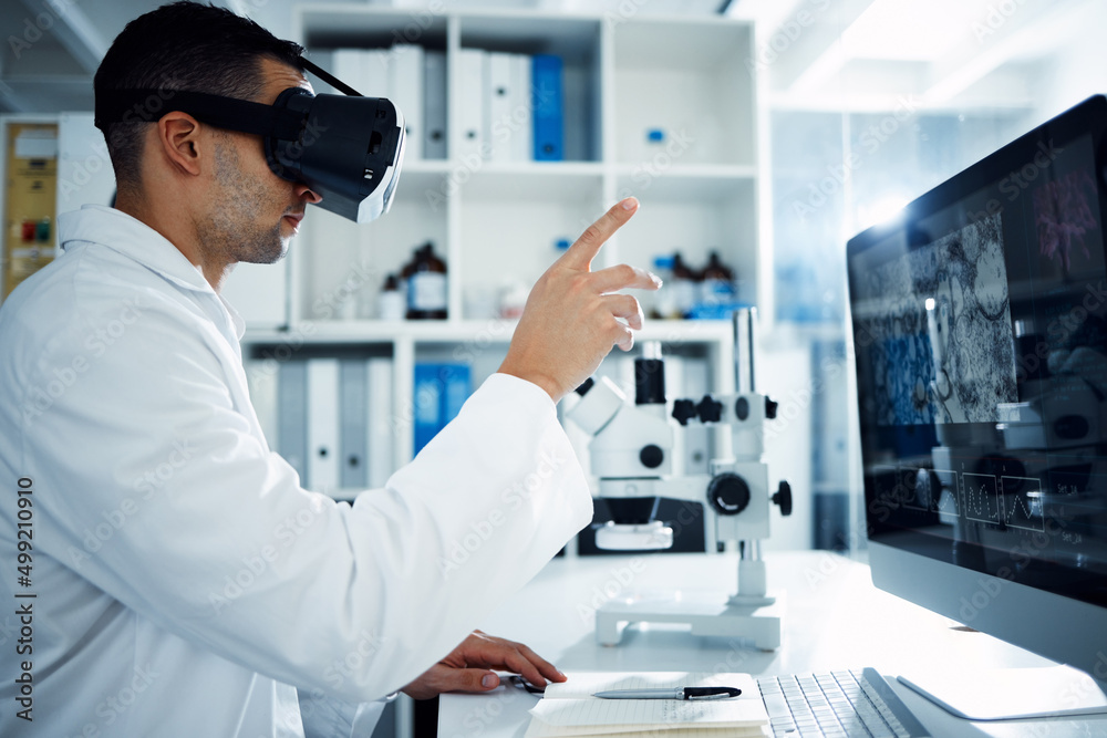 The future is reserved for the progressive. Shot of a scientist using a virtual reality headset while conducting research in a laboratory. The future is reserved for the progressive. Shot of a scientist using a virtual reality headset while conducting research in a laboratory.