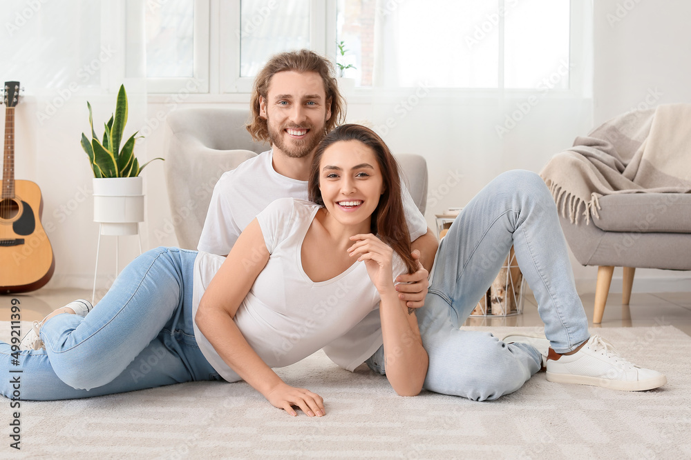 Young couple on soft carpet at home Young couple on soft carpet at home