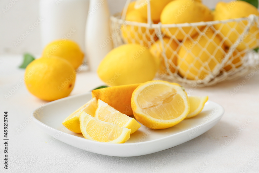 Plate with fresh cut lemon on light table Plate with fresh cut lemon on light table