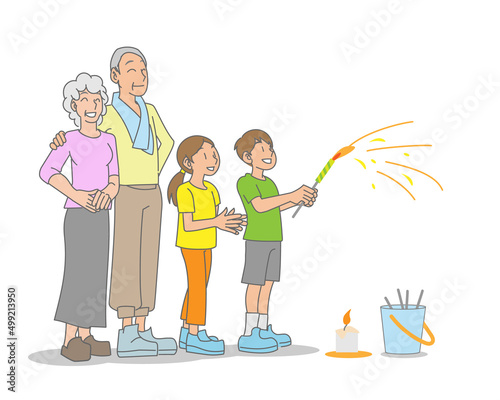 孫と花火を楽しむ祖父母