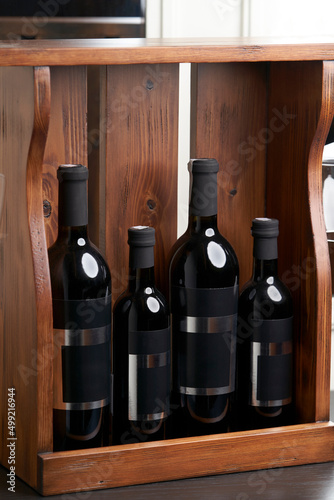 Wine bottles in wooden crate, close-up © Gecko Studio