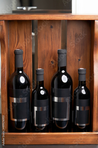 Wine bottles in wooden crate, close-up