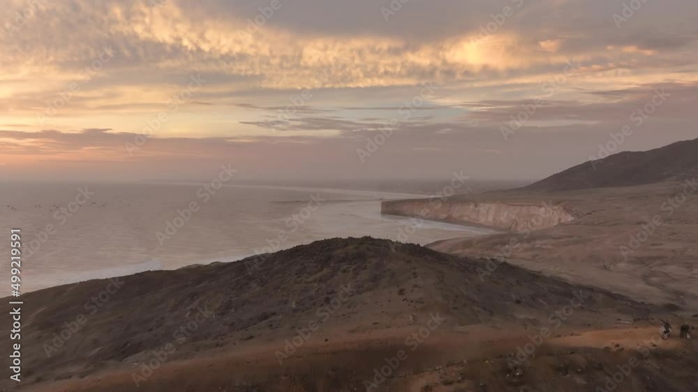 Aerial view of the Puerto Eten lighthouse and two motorcyclists. at sunset, Lambayeque, Peru Aerial view of the Puerto Eten lighthouse and two motorcyclists. at sunset, Lambayeque, Peru