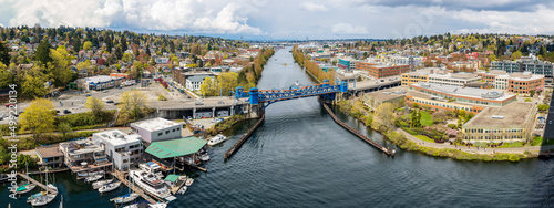 A panorama of the blue Fremont Bridge spans the Fremont cut