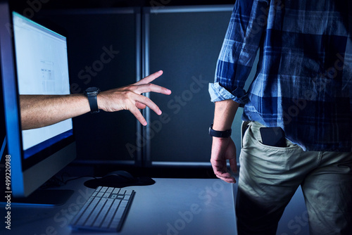 No one is safe from cyber crime. Cropped shot of an unrecognizable male hackers hand reaching out from a computer screen.