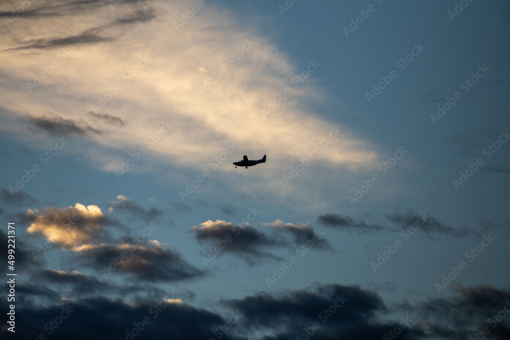 Small Aeroplane in Ominous Clouds Isolated Silhouette