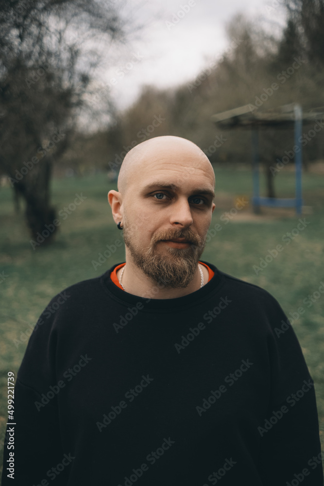 A white man with bald head and beard has a rest in a park A white man with bald head and beard has a rest in a park