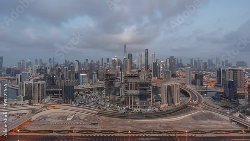 Panoramic skyline of Dubai with business bay and downtown district night to day timelapse. photo