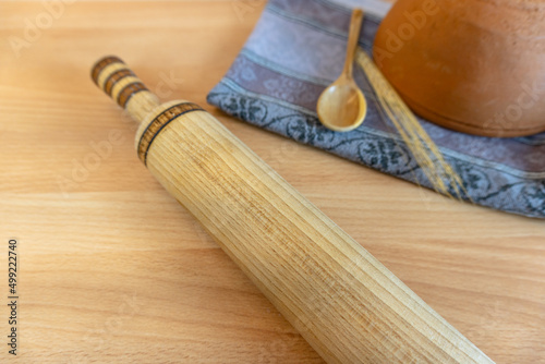 household utensils in the kitchen, rolling pin, wooden mug, kitchen decor