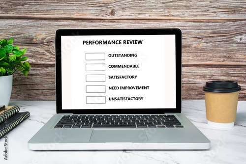 Performance review checklist text on white screen laptop or notebook.