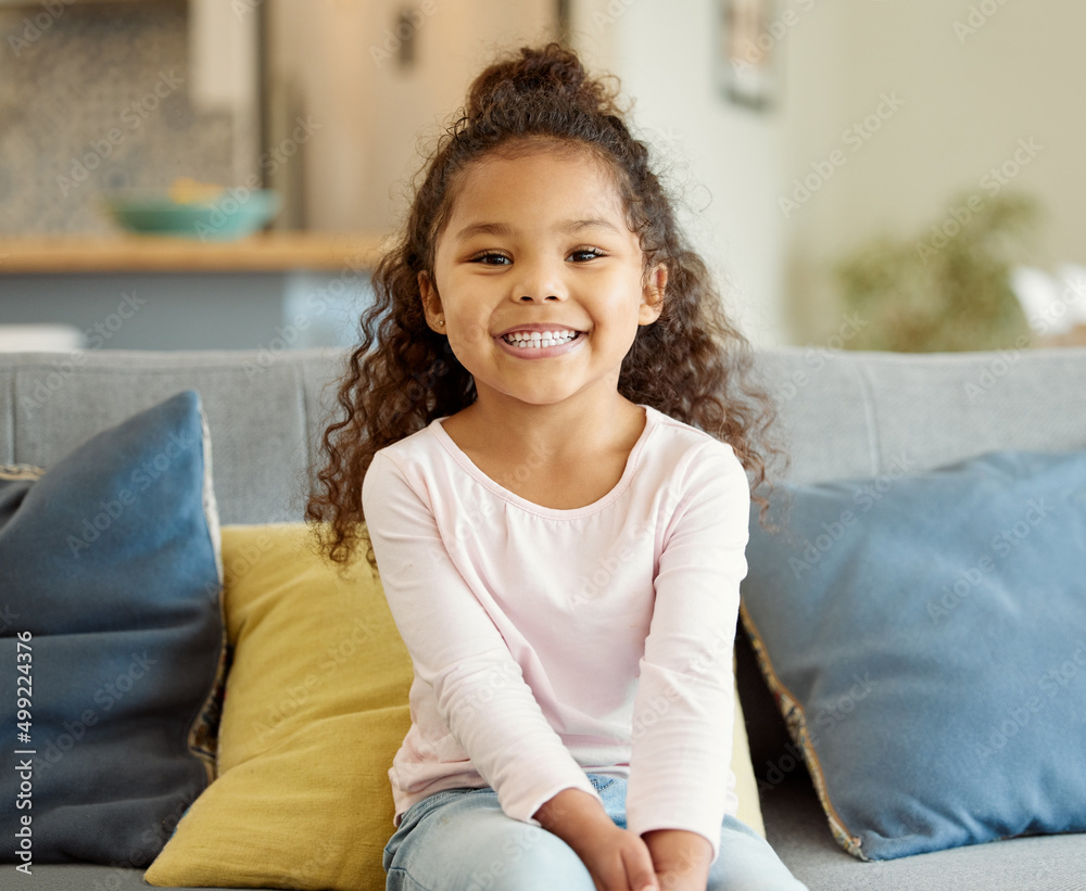 Mum promised loads of fun today. Portrait of a little girl sitting on the sofa at home. Mum promised loads of fun today. Portrait of a little girl sitting on the sofa at home.
