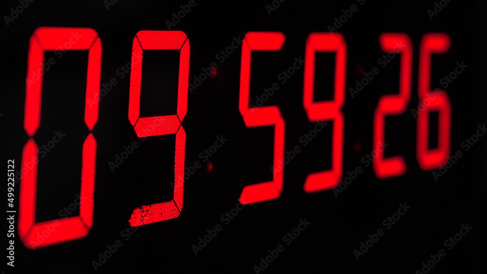 Digital timer on a black background. Light panel with red numbers - obrazy, fototapety, plakaty 