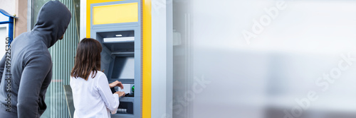 Photos Thief Looking At Woman Entering The Pin In ATM