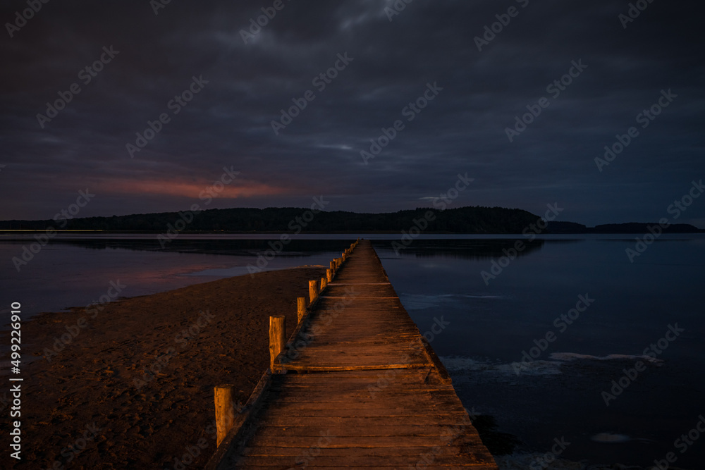 The Jasmunder Bodden coast after dark, with the pier in Lietzow, Mecklenburg-Western Pomerania, Germany