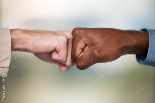 Pump up your business with the power of partnership. Shot of two unrecognisable businesspeople bumping fists.
