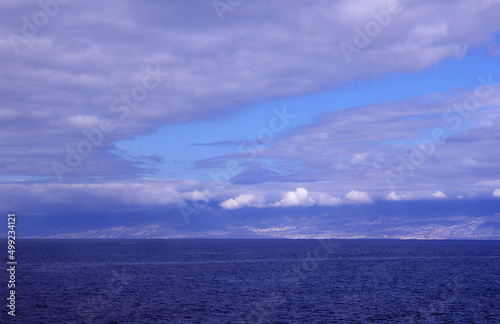 Tenerife,  as seen from the ocaen level, Teide peak partically covered by clouds, 
white structures of Izana observatory visible under it to the right
 photo