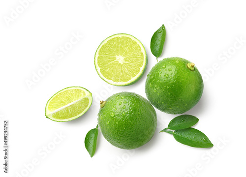 Flat lay of fresh lime with water droplets and cut in half isolated on white background.