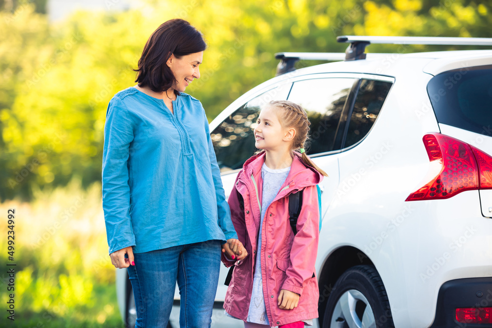 © Ievgen Skrypko - Mother taking primary schoolgirl going to school at parking © Ievgen Skrypko - Mother taking primary schoolgirl going to school at parking
