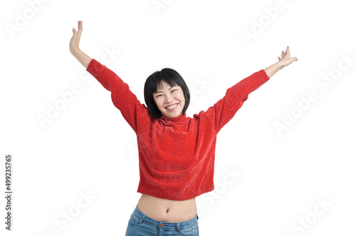 Young asian woman with arms raised and laughing wearing red sweater, isolated.