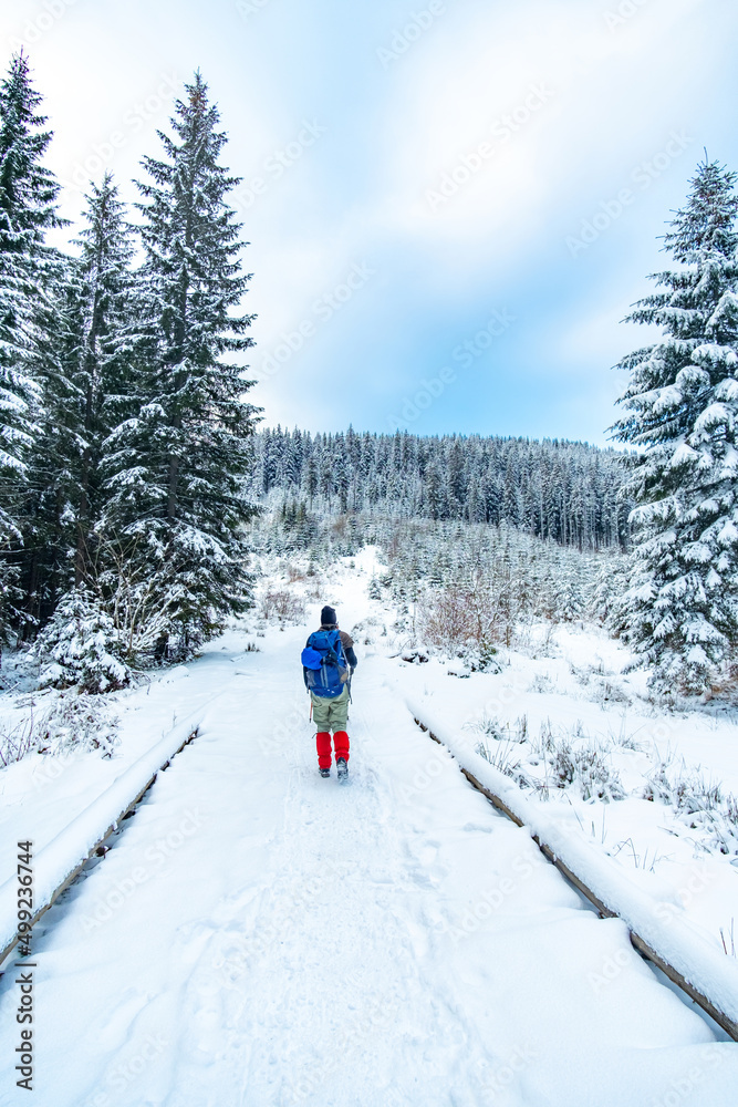 Lonely tourist start to ascend snowy mountain in winter