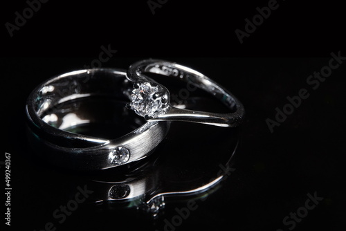 Two diamond ring on black background.