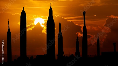 Cape Canaveral at Sunset, Time Lapse with Red Sky, Fiery Sun and Silhouette of Rockets in the Rocket garden at Kennedy Space Center, USA photo