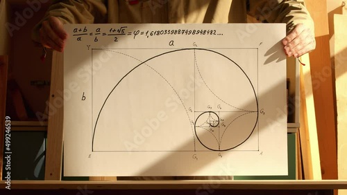 Mathematician shows paper with a golden spiral drawing. Reverse playback video. Date of shooting day 24 March 2022 year, MSK time. This video was filmed in Russia.
