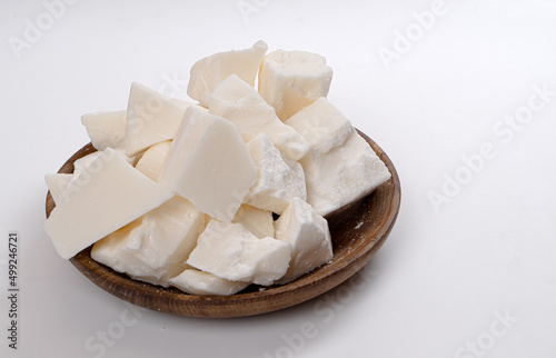 Lumpy vegetable fat of white color on a white background in a plate