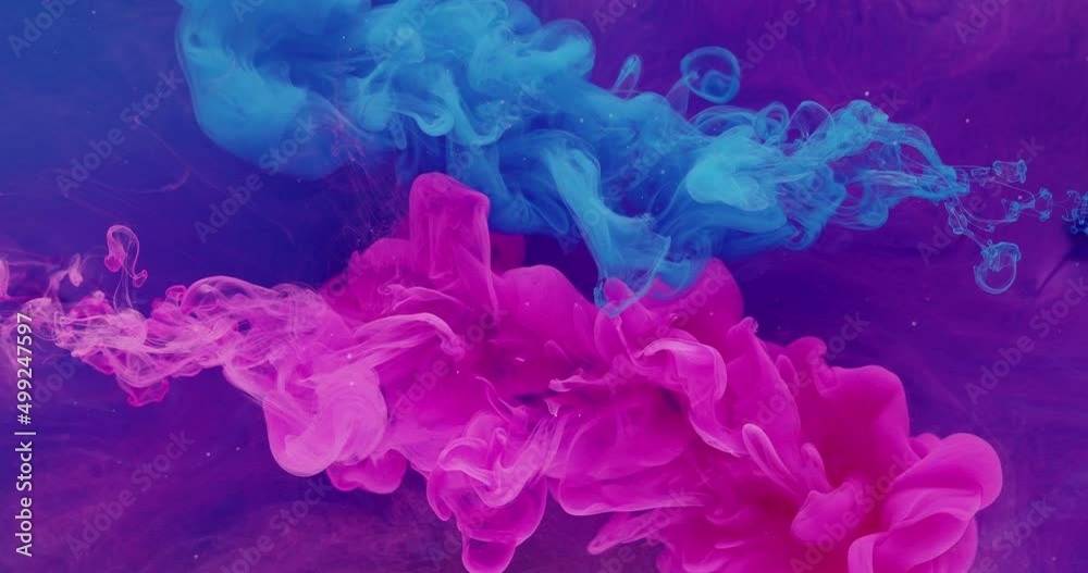 Paint water drop. Color explosion. Transition layer. Neon pink blue ink splash on bright purple smoke cloud abstract background shot on Red Cinema camera 6k. Paint water drop. Color explosion. Transition layer. Neon pink blue ink splash on bright purple smoke cloud abstract background shot on Red Cinema camera 6k.