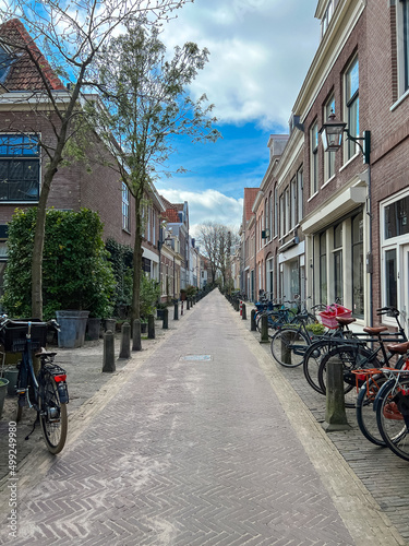 streetview in a dutch city with bicycles and old houses 