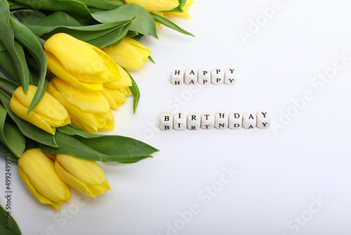 Spring composition. Delicate yellow tulips on white background top view space for text border. bouquet of fresh yellow tulips on white background 