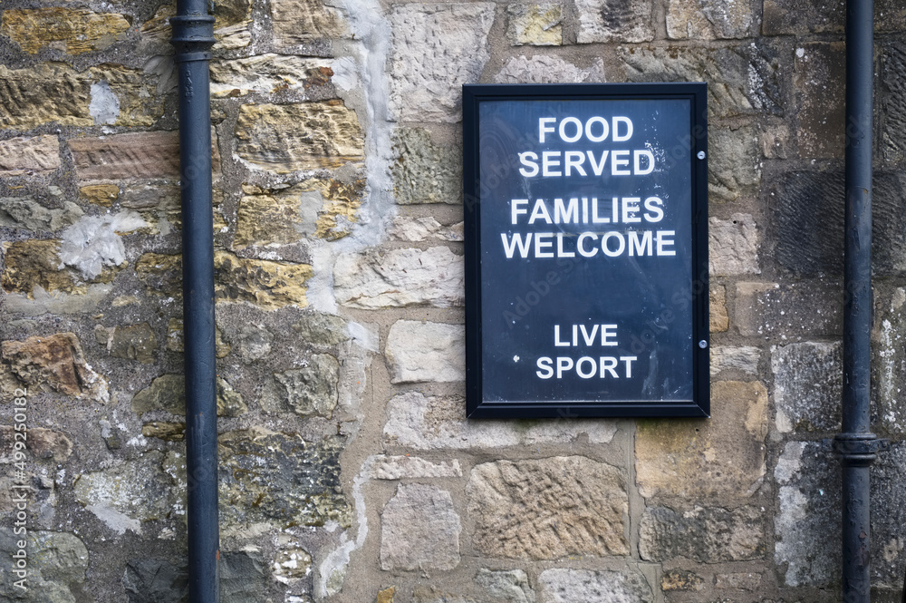 Food served families welcome sign on wall of restaurant Food served families welcome sign on wall of restaurant
