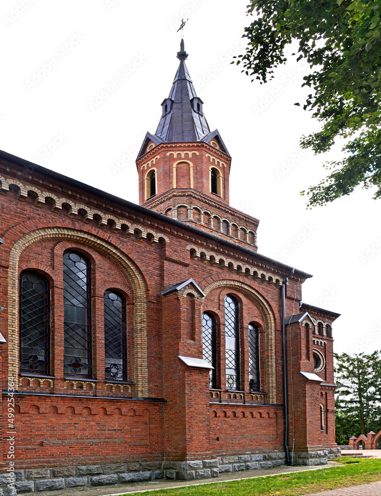 Obraz premium General view and architectural details of a close-up of the Catholic church of St. Michael the Archangel built at the turn of the 19th and 20th centuries in Jabłonka Koscielna in Podlasie, Poland.